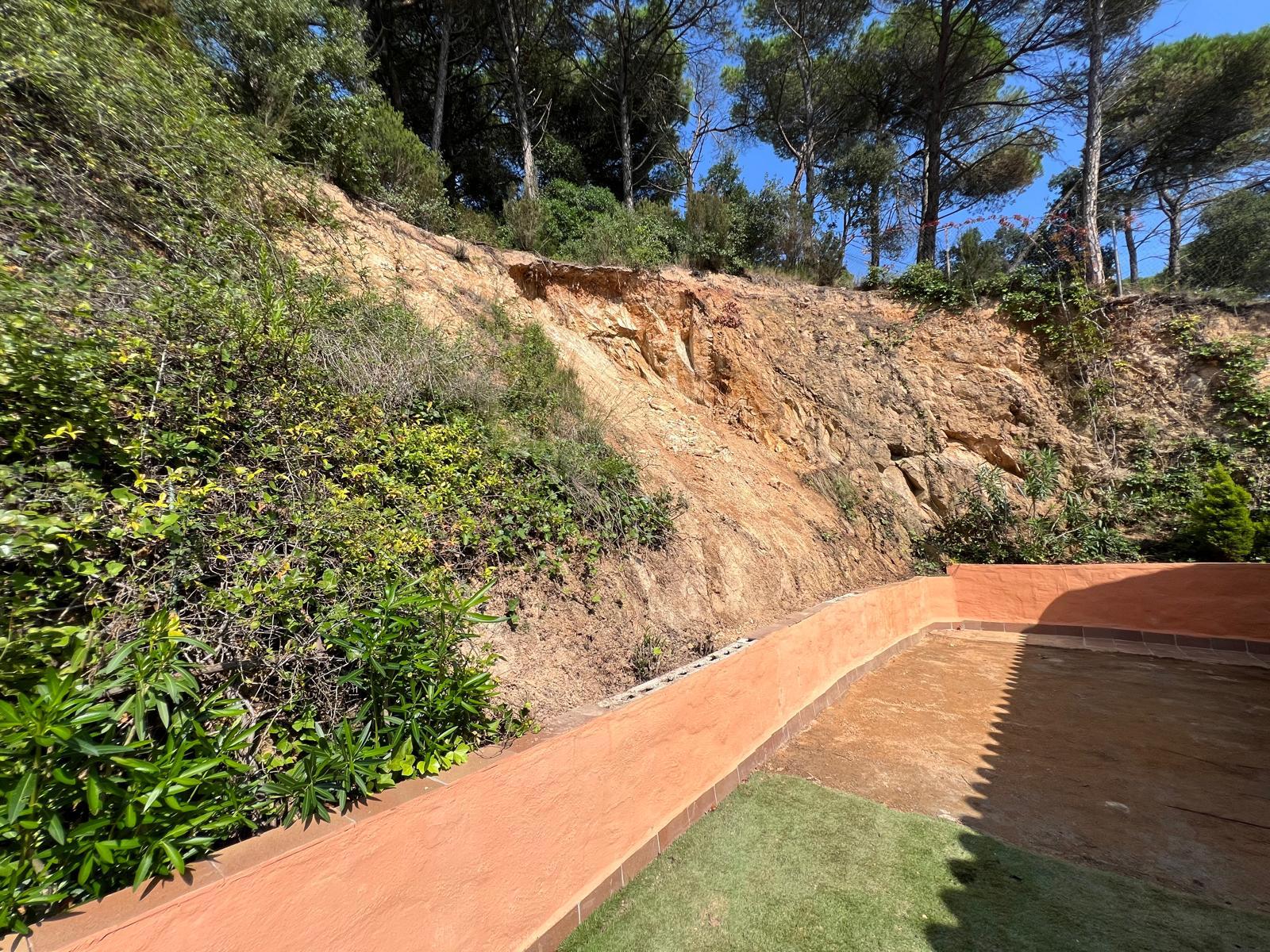 Clean and profiled rock slope after landslide removal and stabilization